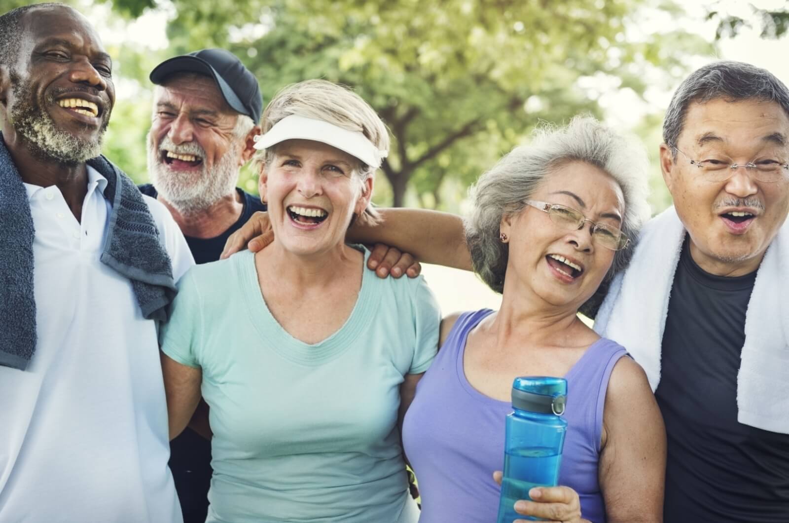 A group of older adults sharing hearty laughter and genuine smiles, their faces aglow with satisfaction after completing their morning exercise routine.