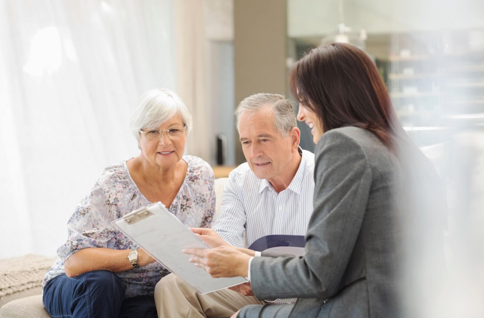 A couple of seniors discuss their finances with a financial planner to determine if a rental senior living community is the right choice for them.