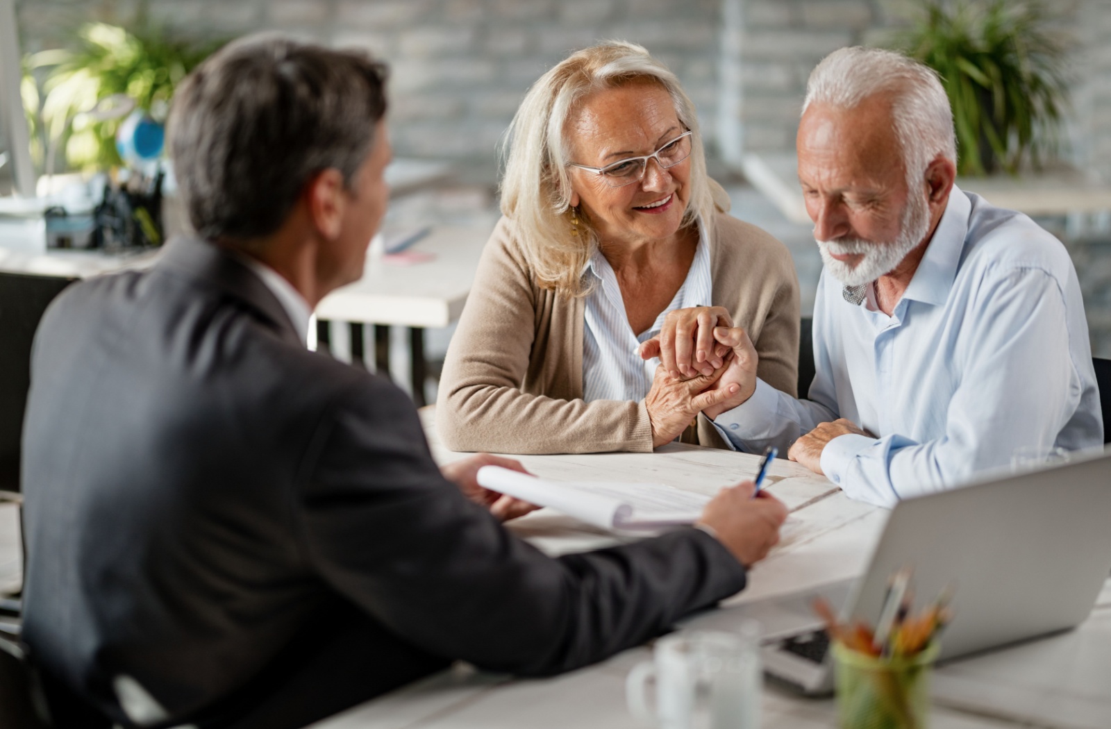 A senior couple discusses their tax situation with a tax professional.