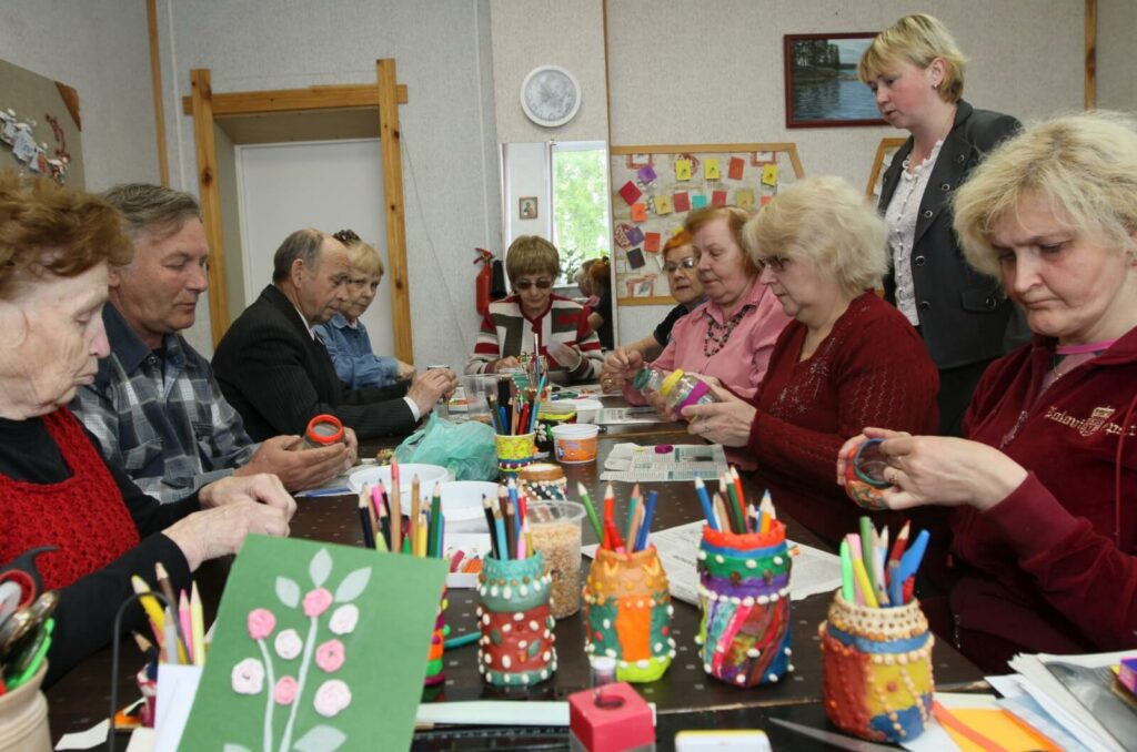 A group of older adults engaged in the joyful process of creating art.